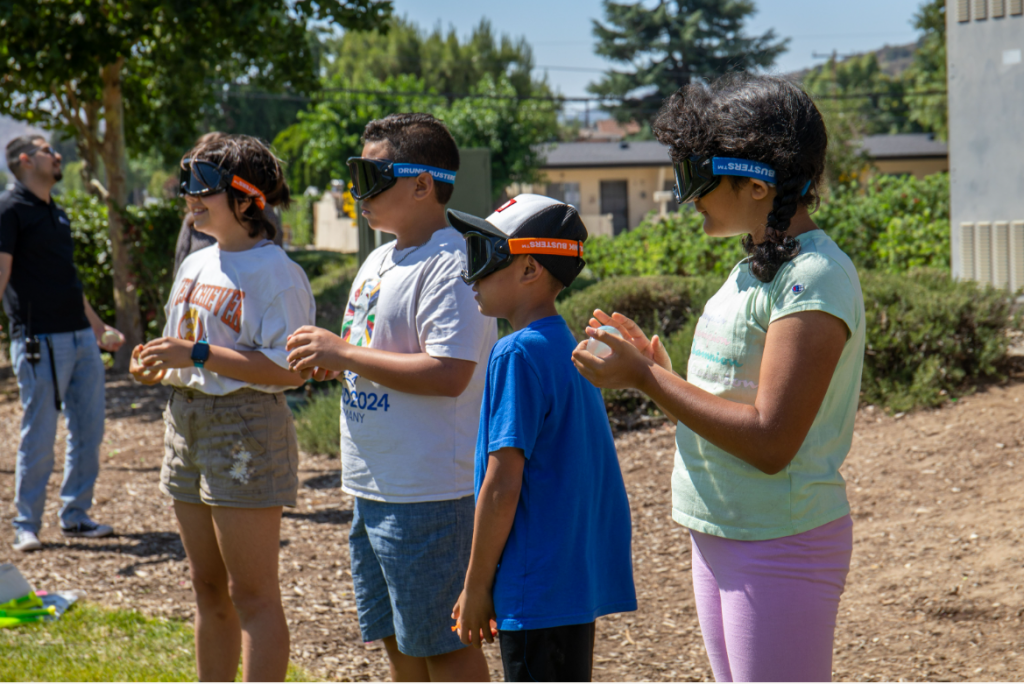 Kids at the Newhall Community Center wearing impairment goggles as they learn the dangers of alcohol.